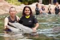 Survivor Player Yau-Man Chan and two-time winner Sandra Diaz-Twine with Dexter, at Discovery Cove in Orlando
