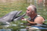 Survivor first winner Richard Hatch meets Dexter the dolphin at Discovery Cove in Orlando