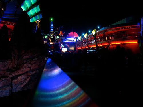 Tomorrowland railing rainbow at night