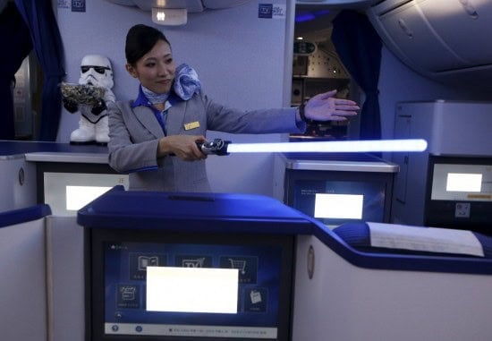 a-stewardess-uses-a-light-saber-to-demonstrate-the-features-of-the-business-class-section-during-november-the-plane-will-be-flying-domestic-routes-in-japan